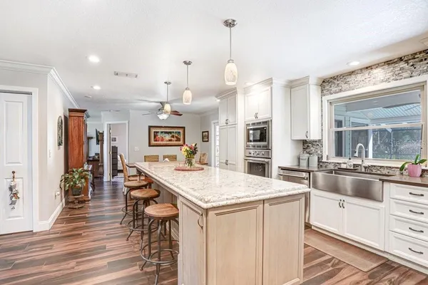 a living room with furniture and kitchen view