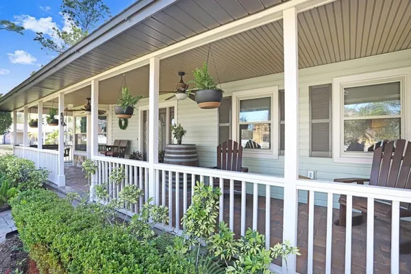 a living room with fireplace furniture and a rug