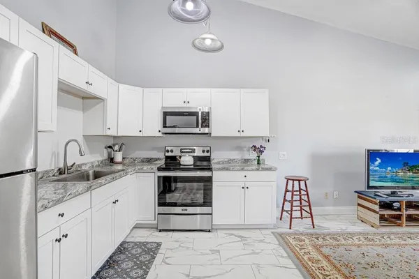 an aerial view of a residential houses with outdoor space