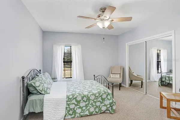 an aerial view of residential house with outdoor space and trees all around