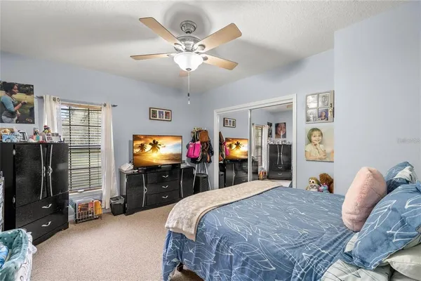a view of a house with a big yard and large trees