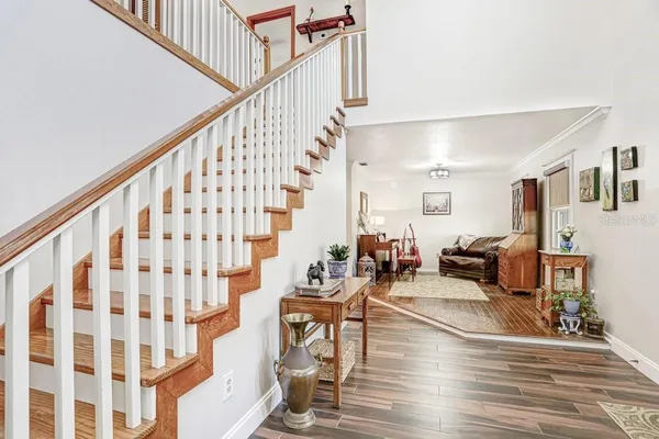 a view of a dining room with furniture and a chandelier