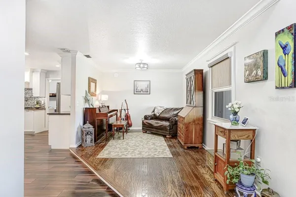 a kitchen with stainless steel appliances kitchen island granite countertop a table chairs sink and cabinets