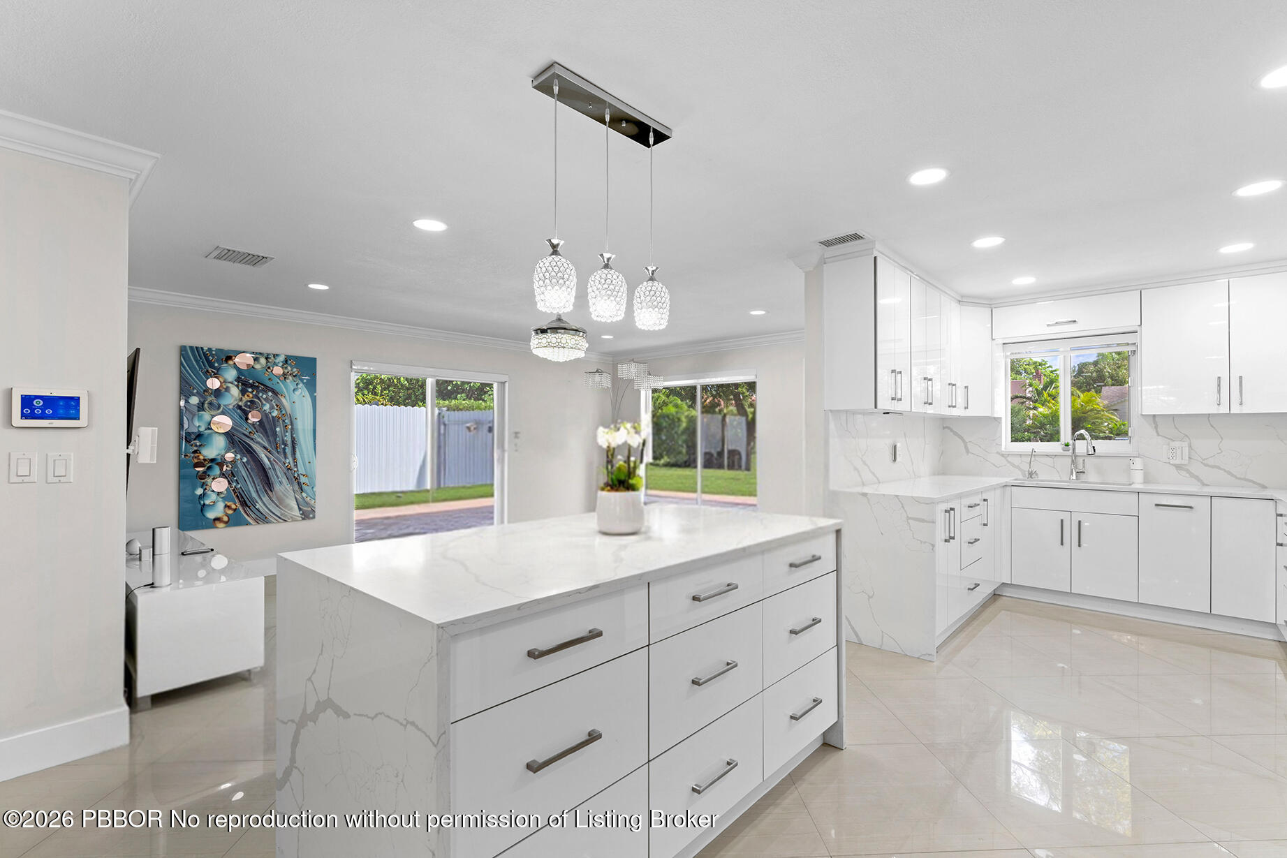 747 Avon Road West Palm Beach, FL 33401 - Photo 3 of 29 a large kitchen with kitchen island white cabinets and stainless steel appliances