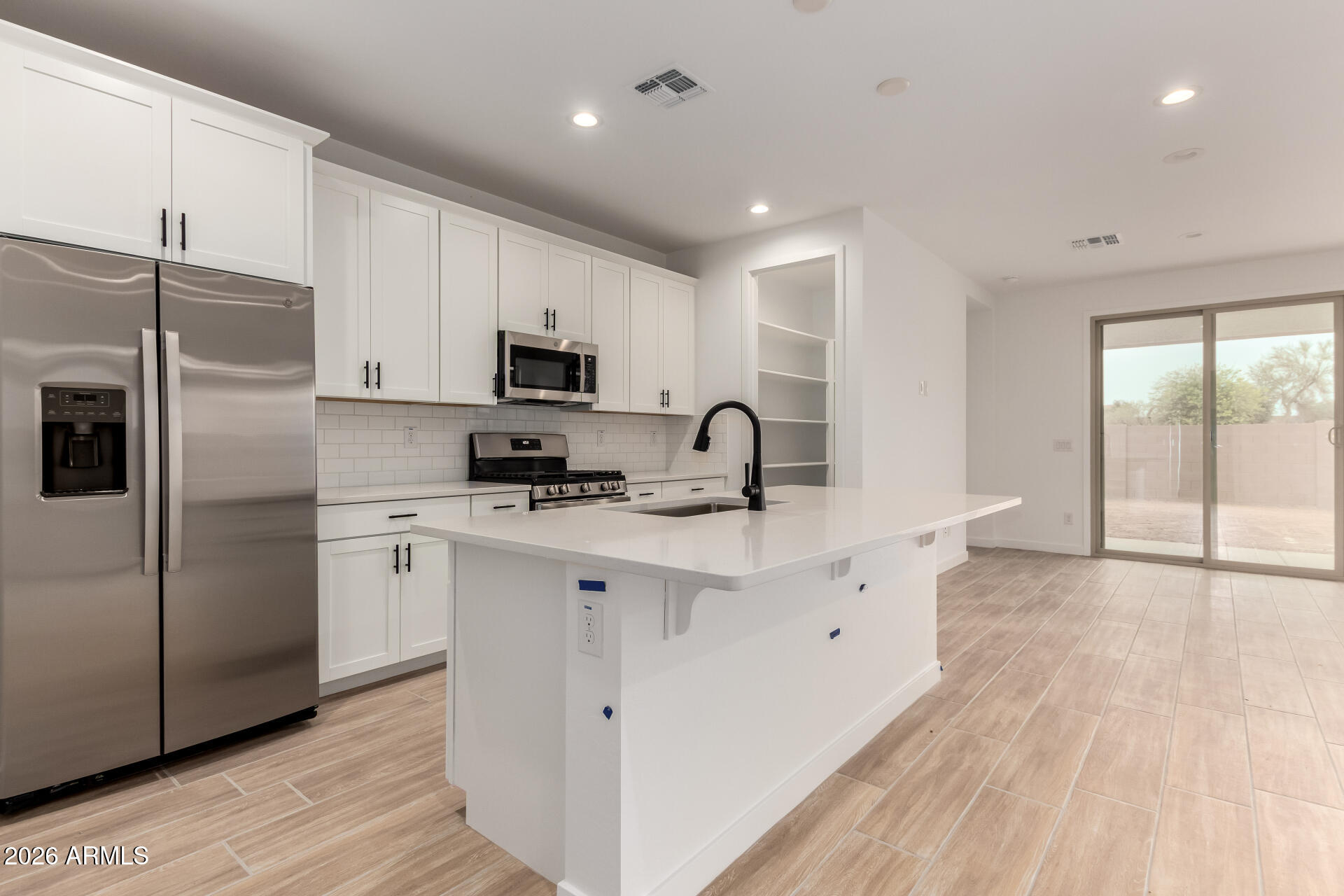 8026 West Granada Road Phoenix, AZ 85035 - Photo 2 of 31 a kitchen with stainless steel appliances a refrigerator sink and microwave