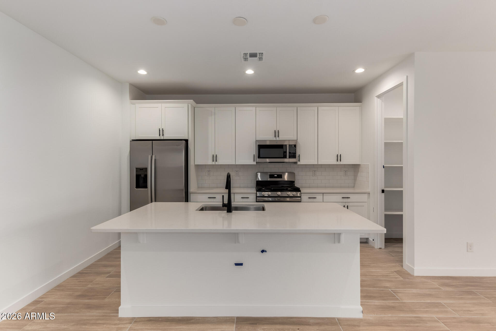8026 West Granada Road Phoenix, AZ 85035 - Photo 3 of 31 a kitchen with stainless steel appliances a refrigerator sink and stove