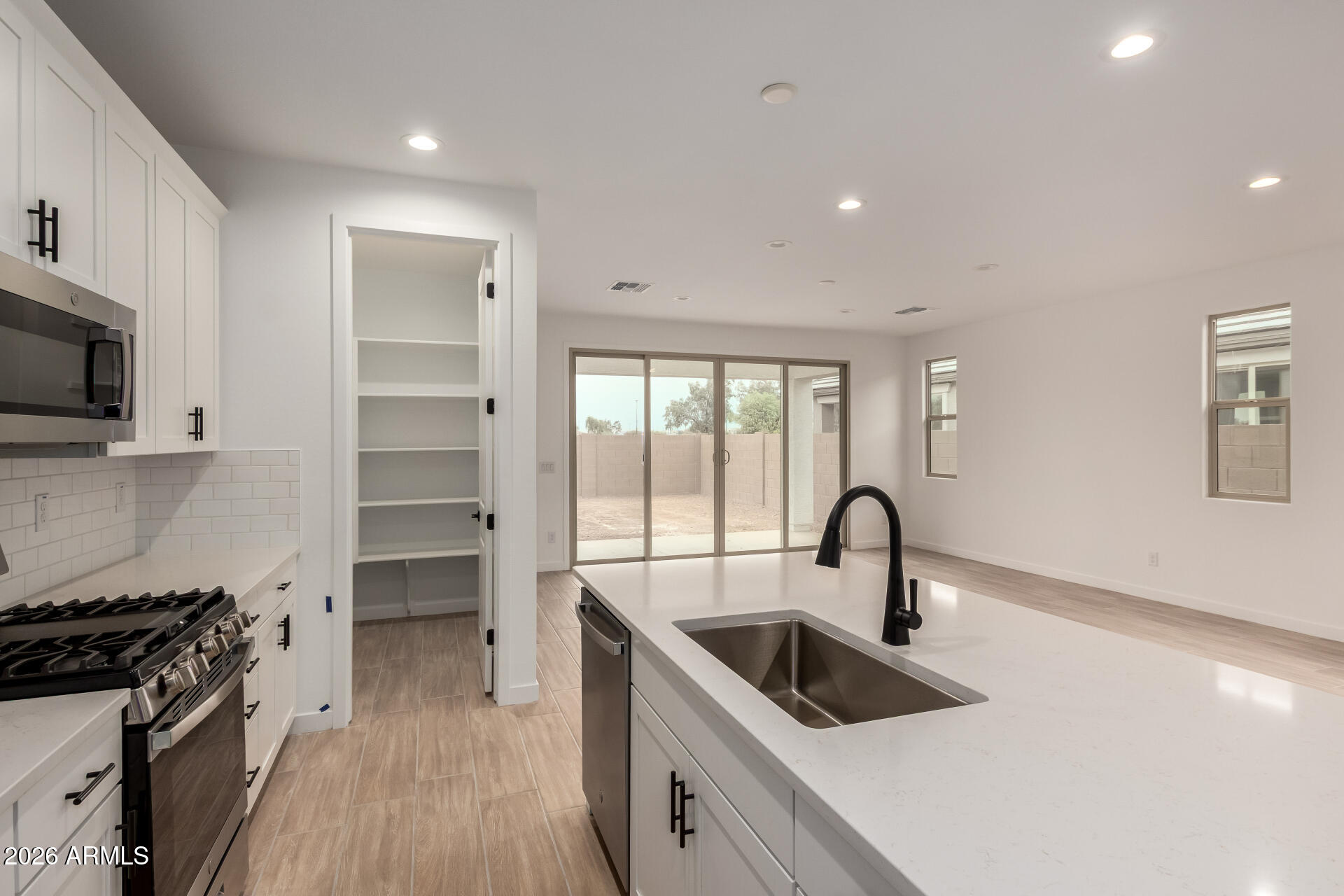 8026 West Granada Road Phoenix, AZ 85035 - Photo 4 of 31 a kitchen with granite countertop a sink stove and refrigerator