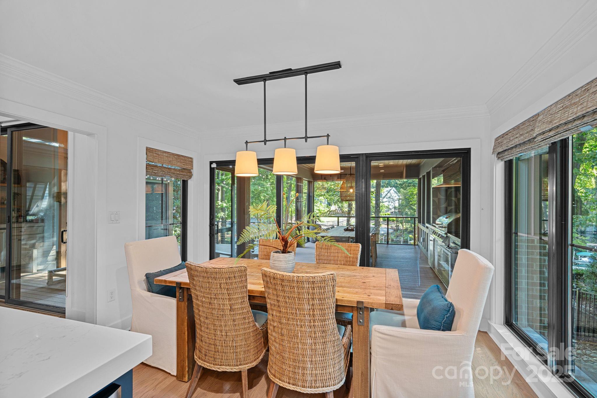 19624 Meta Road Cornelius, NC 28031 - Photo 12 of 44 a dining room with furniture large windows and wooden floor