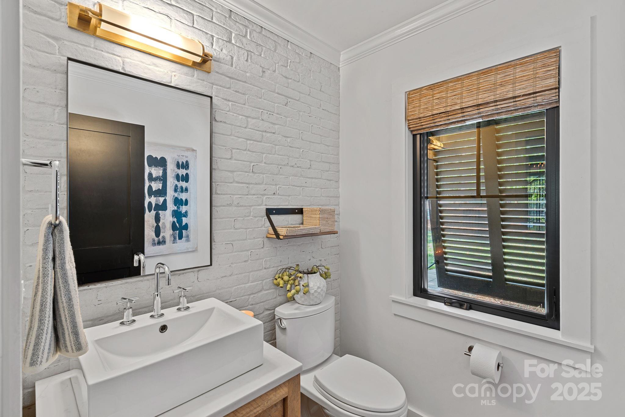 19624 Meta Road Cornelius, NC 28031 - Photo 16 of 44 a bathroom with a sink a toilet and a mirror