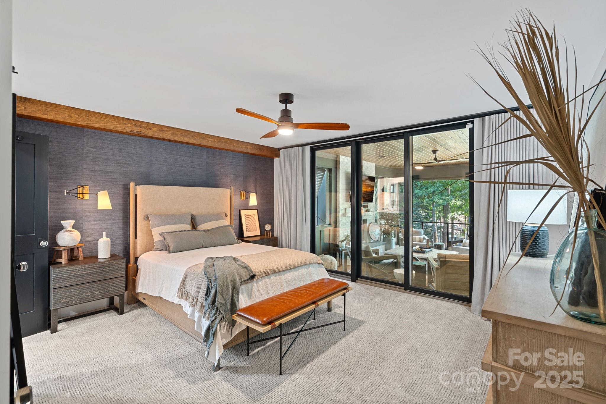 19624 Meta Road Cornelius, NC 28031 - Photo 19 of 44 a bedroom with a large bed and a chandelier