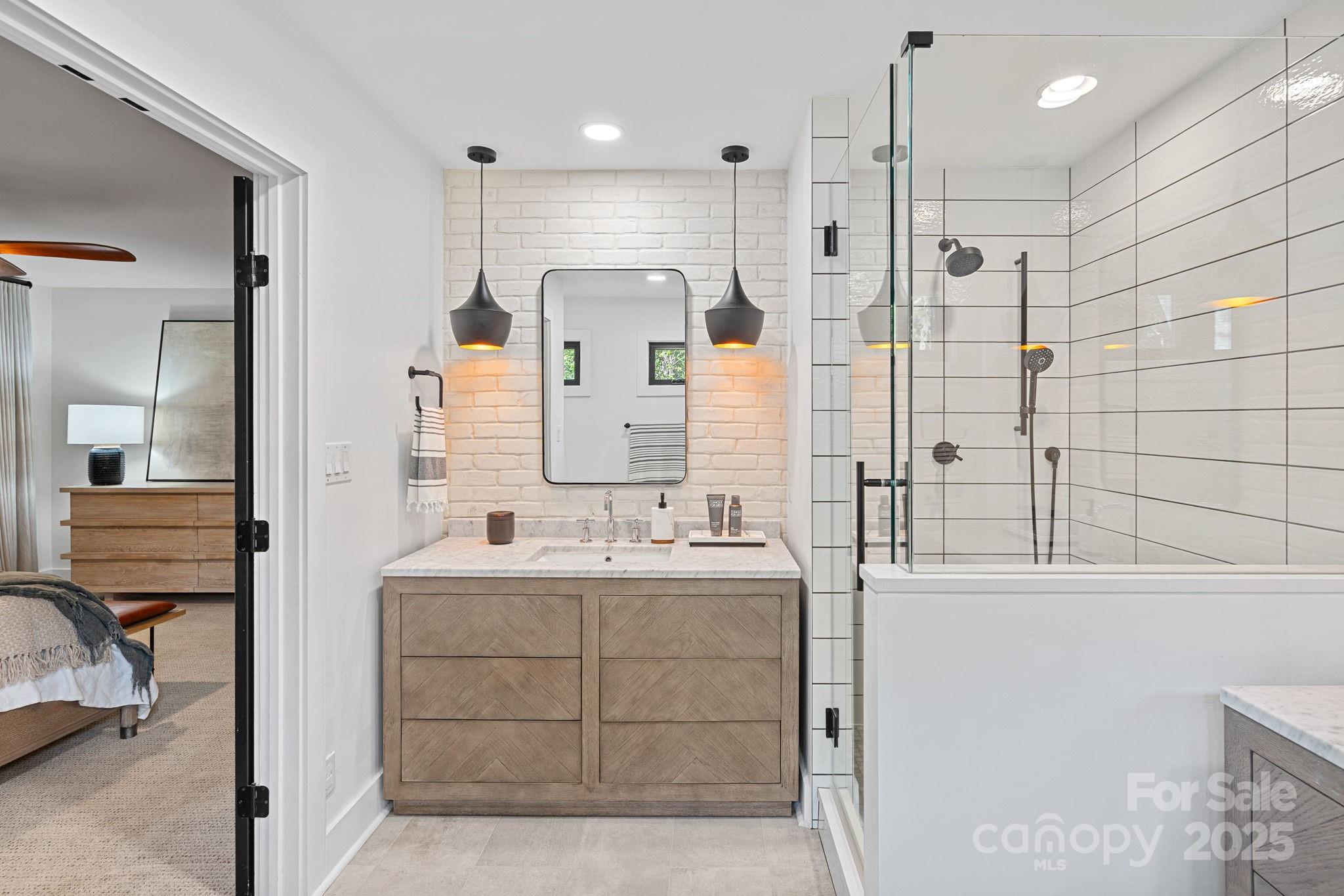 19624 Meta Road Cornelius, NC 28031 - Photo 21 of 44 a bathroom with a double vanity sink mirror and shower