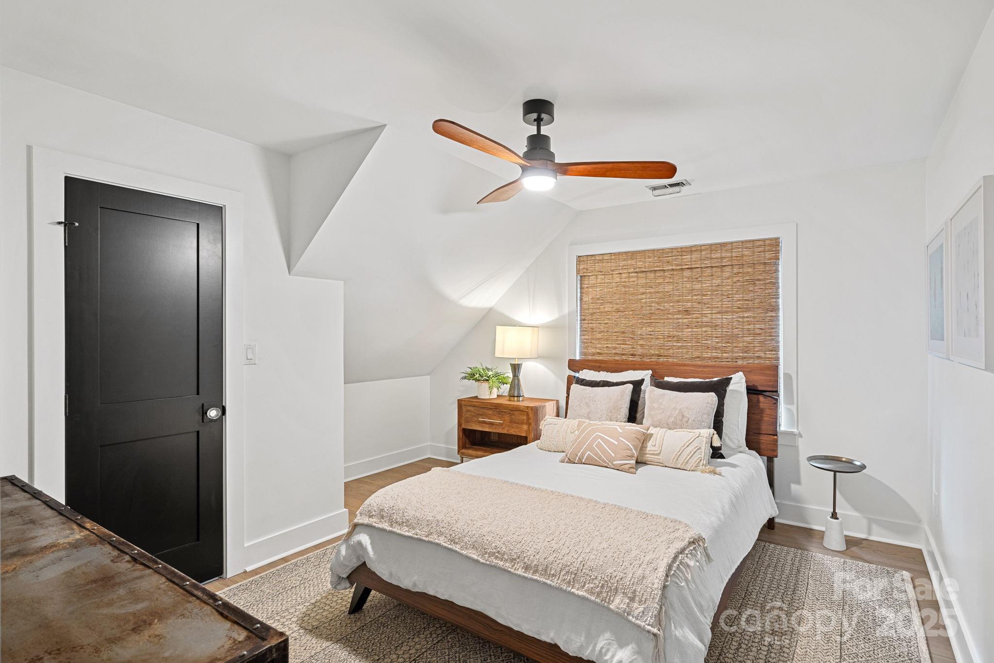 19624 Meta Road Cornelius, NC 28031 - Photo 25 of 44 a bedroom with a bed and wooden floor