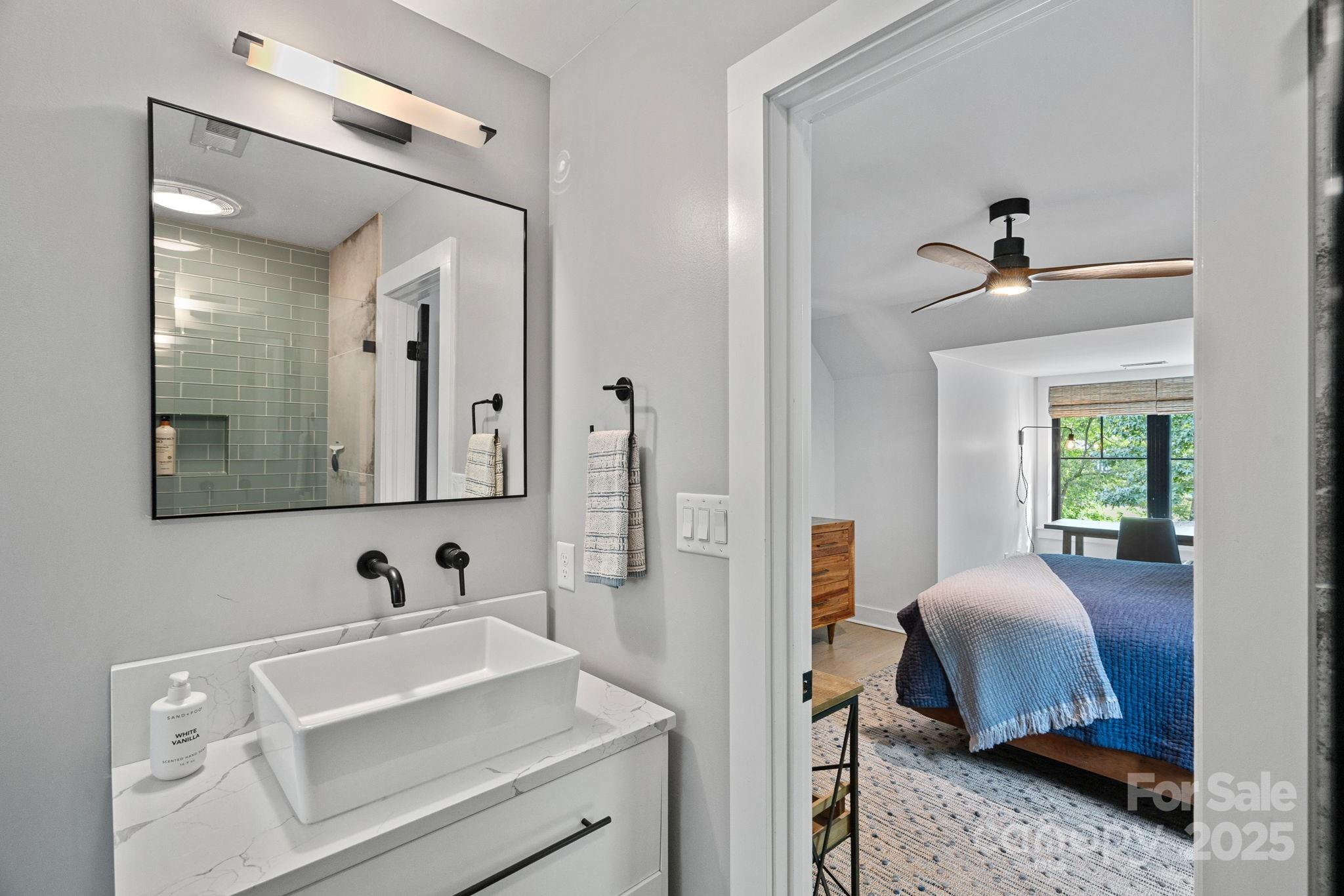 19624 Meta Road Cornelius, NC 28031 - Photo 33 of 44 a en suite bathroom with a toilet sink and mirror