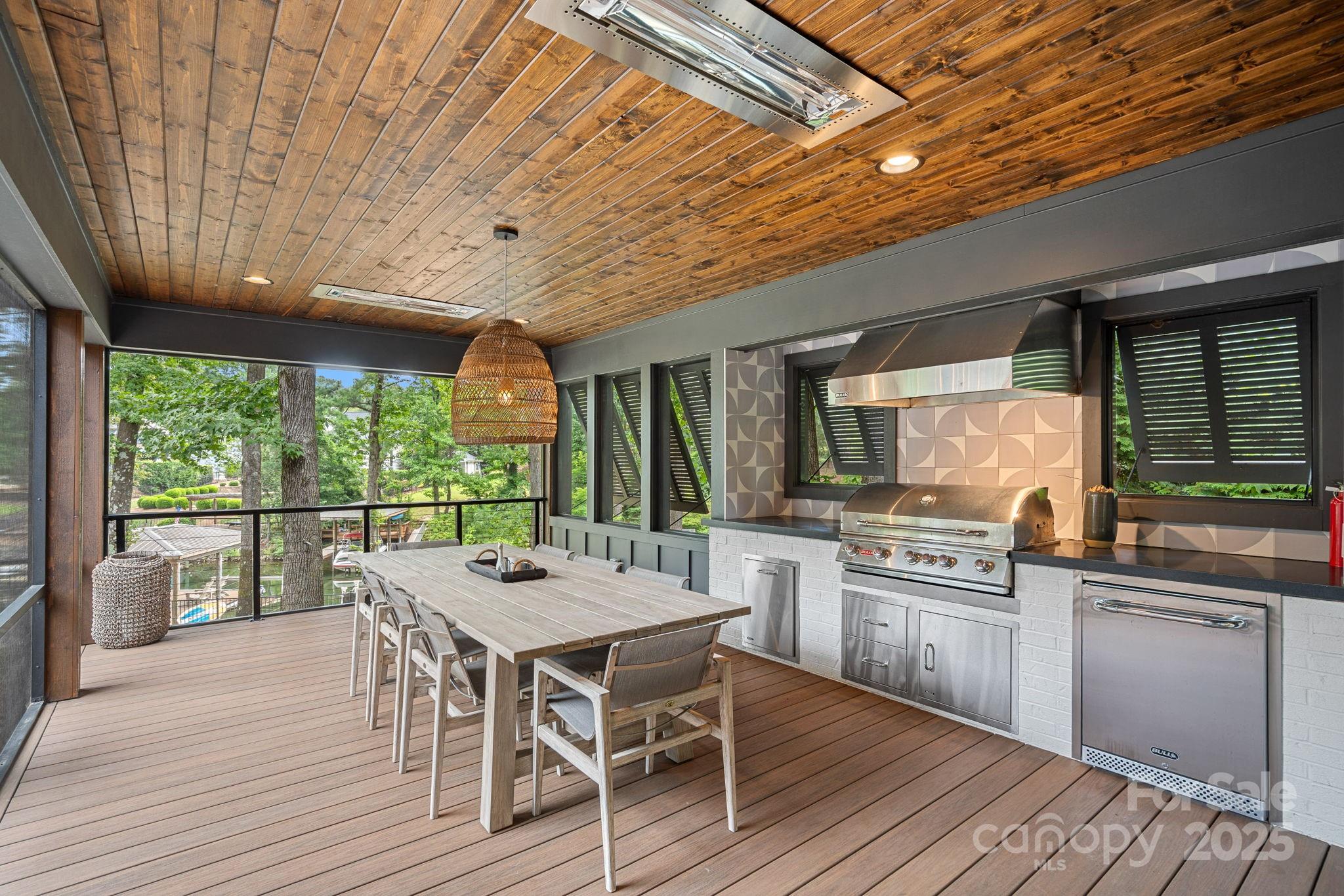 19624 Meta Road Cornelius, NC 28031 - Photo 34 of 44 a kitchen with stainless steel appliances granite countertop a stove top oven a sink dishwasher a dining table and chairs with wooden floor