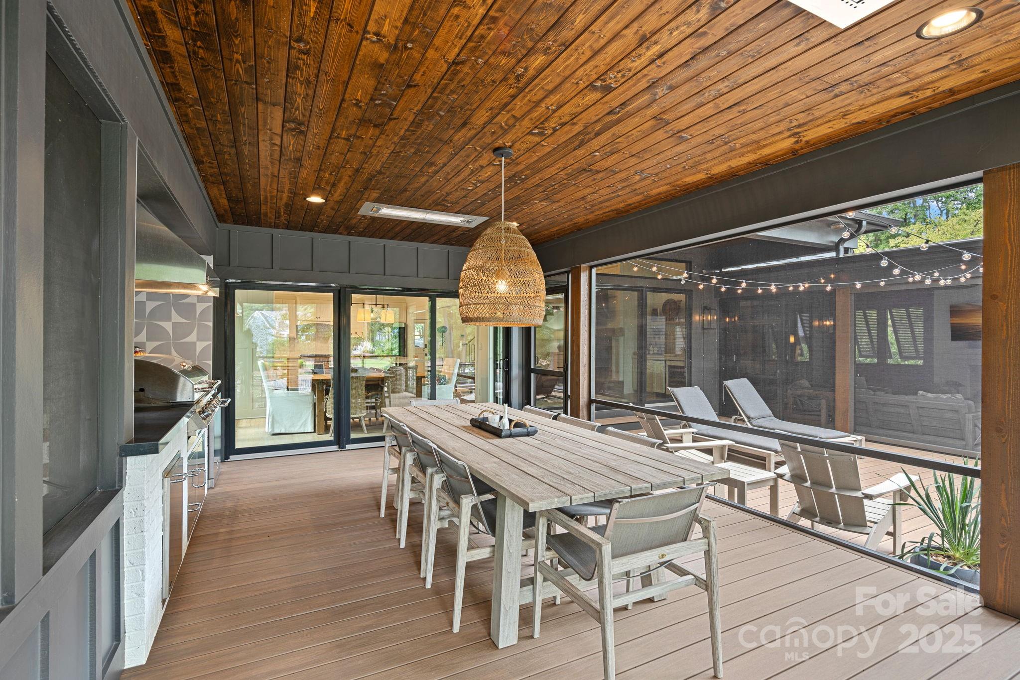 19624 Meta Road Cornelius, NC 28031 - Photo 36 of 44 a dining room with furniture large windows and a chandelier