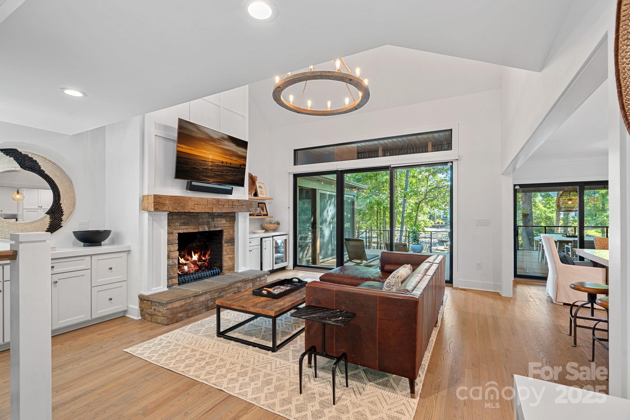 19624 Meta Road Cornelius, NC 28031 - Photo 5 of 44 a living room with furniture a fireplace and a flat screen tv