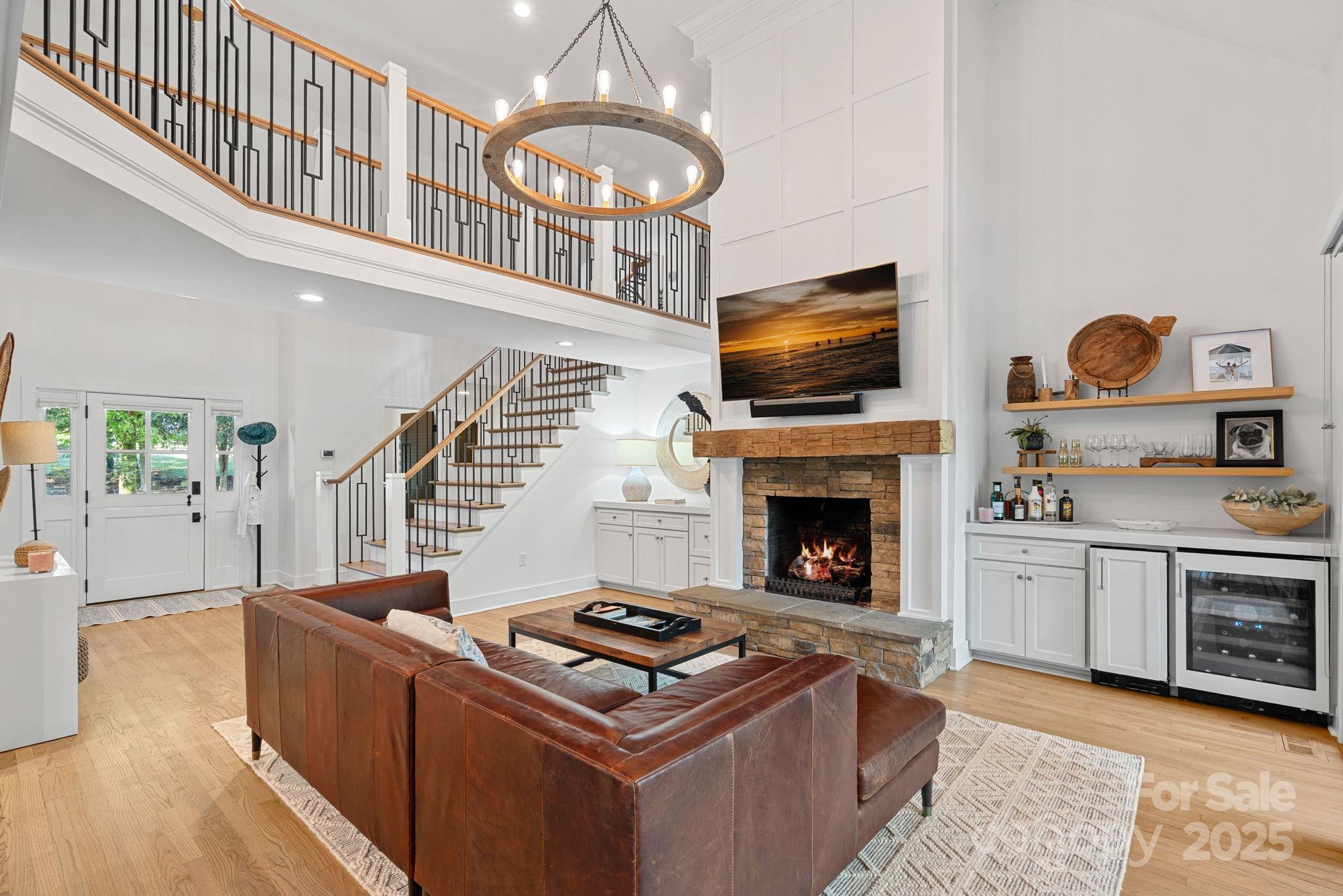 19624 Meta Road Cornelius, NC 28031 - Photo 7 of 44 a living room with furniture a fireplace and flat screen tv