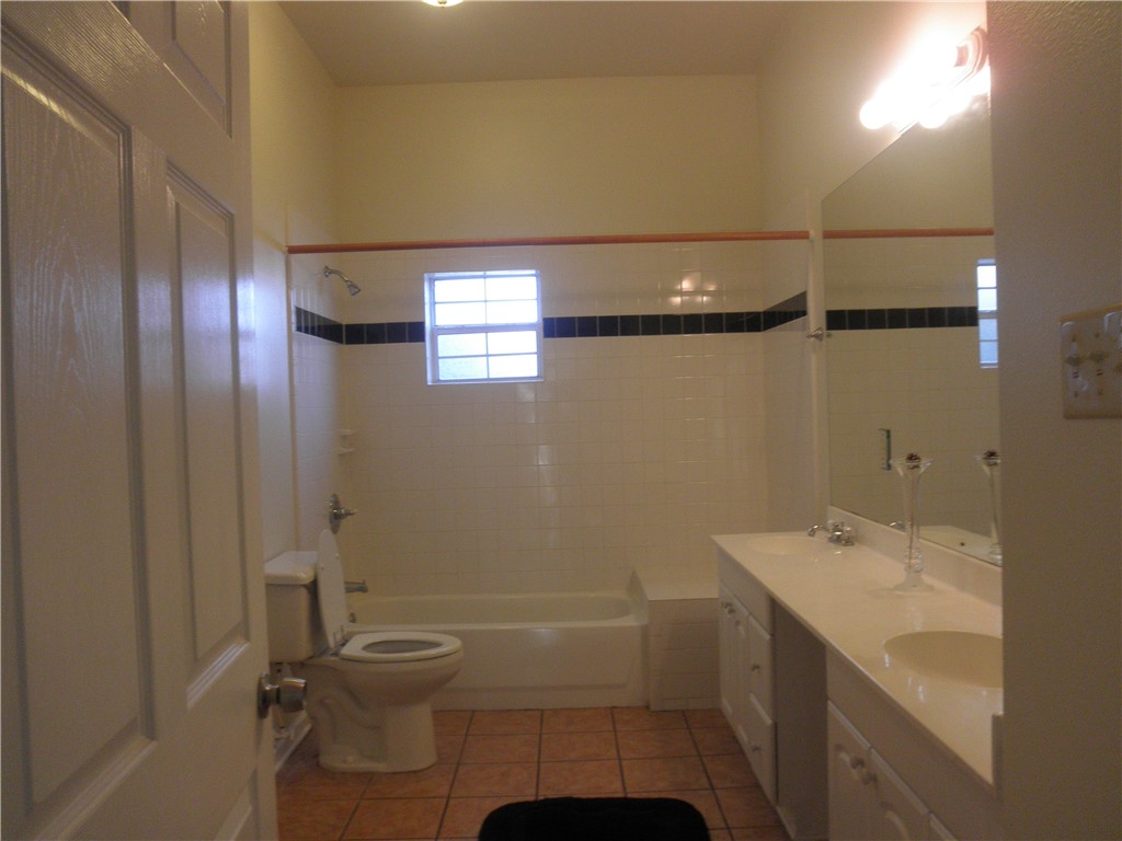 109 West 38th Street, Unit A Austin, TX 78705 - Photo 8 of 16 a bathroom with a granite countertop sink toilet and shower