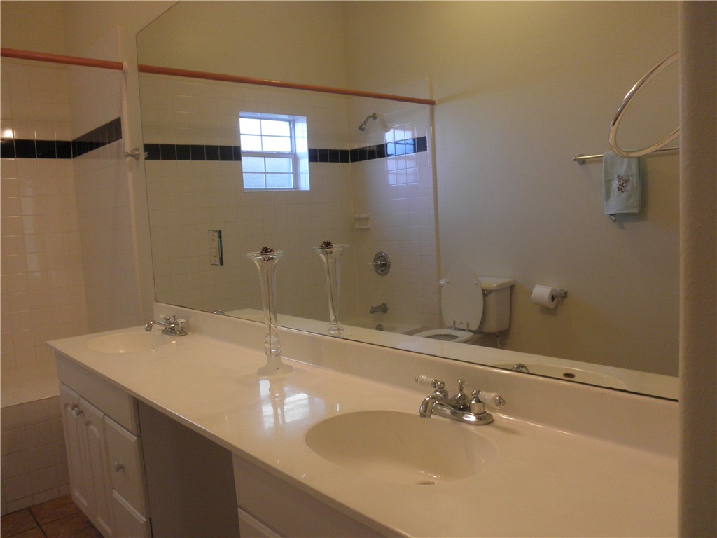 109 West 38th Street, Unit A Austin, TX 78705 - Photo 9 of 16 a bathroom with a sink and a mirror