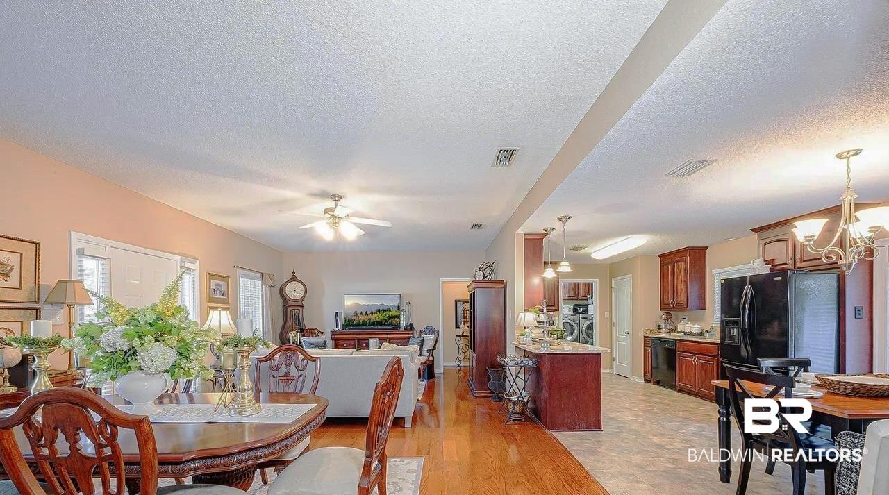 12230 Bromley Road Stapleton, AL 36578 - Photo 11 of 34 Dining space featuring light wood-style floors, a chandelier, a textured ceiling, and a ceiling fan