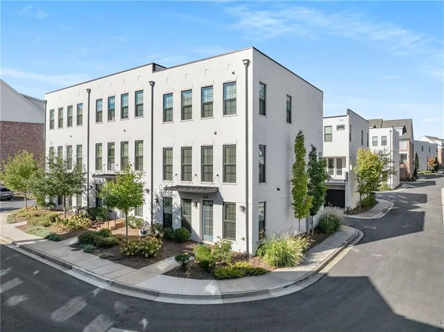 a front view of a house with yard and green space