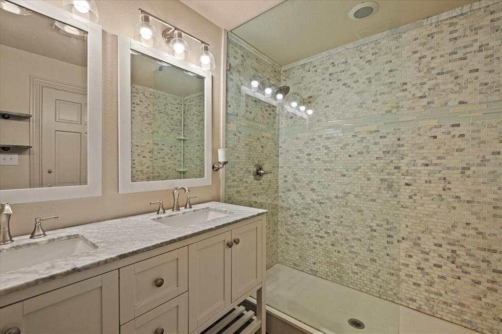 601 North Main Street Leonard, TX 75452 - Photo 20 of 34 a bathroom with a granite countertop sink a mirror and a bathtub
