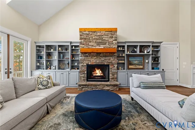 a large kitchen with stainless steel appliances kitchen island granite countertop a large counter top and a wooden floors