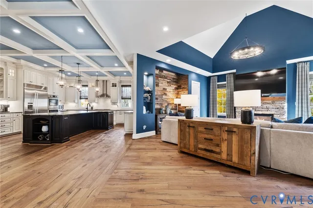 a kitchen with stainless steel appliances granite countertop a sink and wooden cabinets