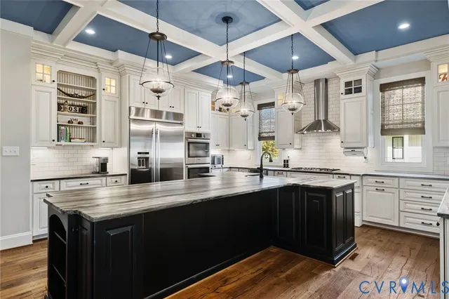 a kitchen with stainless steel appliances granite countertop a stove and a sink