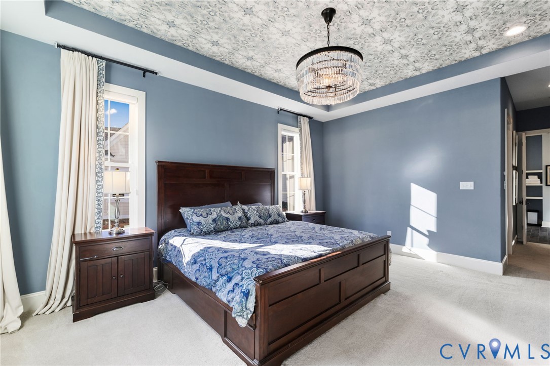 16118 Old Castle Road Midlothian, VA 23112 - Photo 26 of 50 a bedroom with a bed and a chandelier