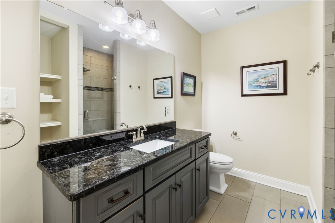16118 Old Castle Road Midlothian, VA 23112 - Photo 43 of 50 a bathroom with a granite countertop sink a toilet and a mirror
