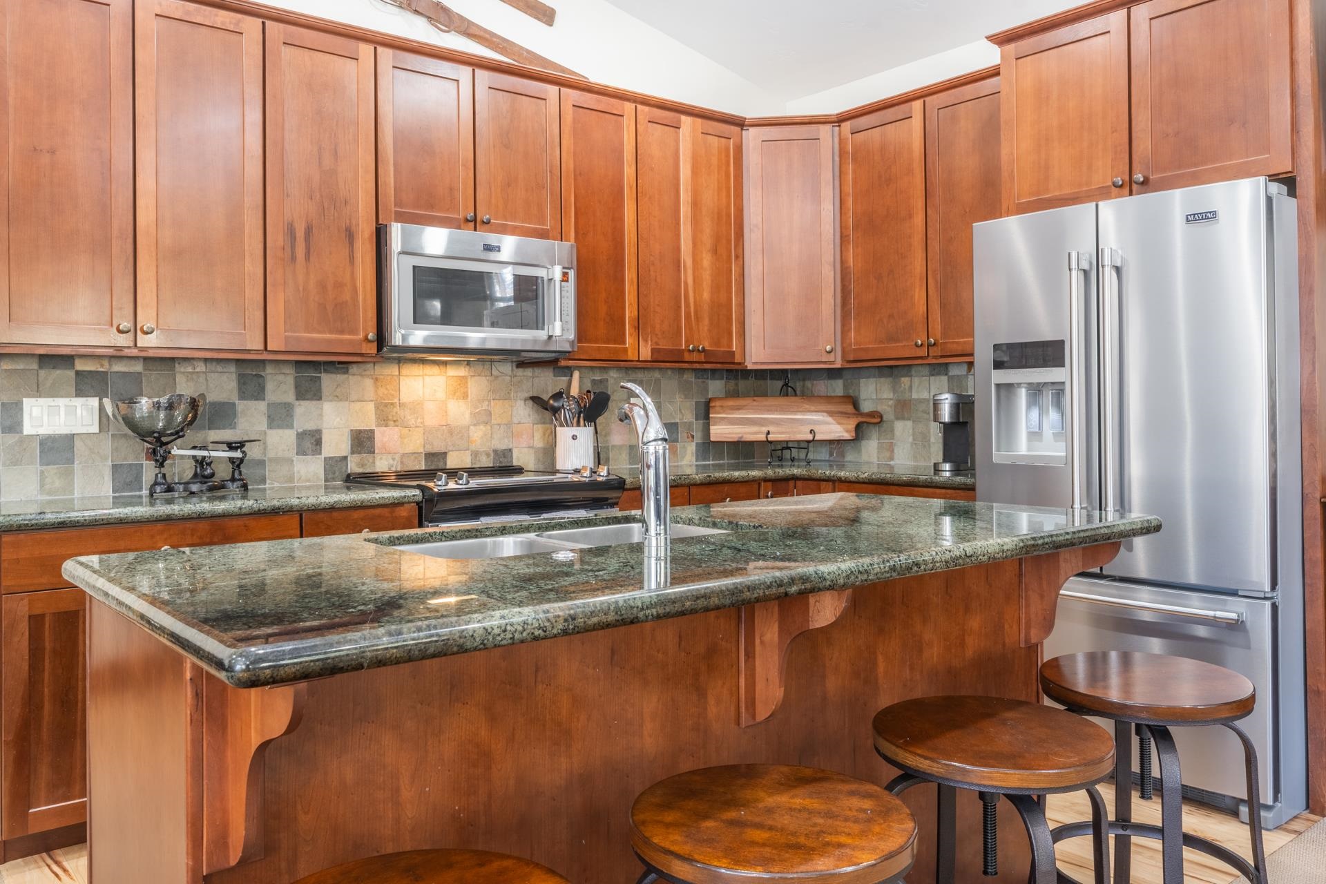 125 Davison Road, Unit 1 Mammoth Lakes, CA 93546 - Photo 8 of 46 a kitchen with stainless steel appliances granite countertop a stove a sink and a refrigerator