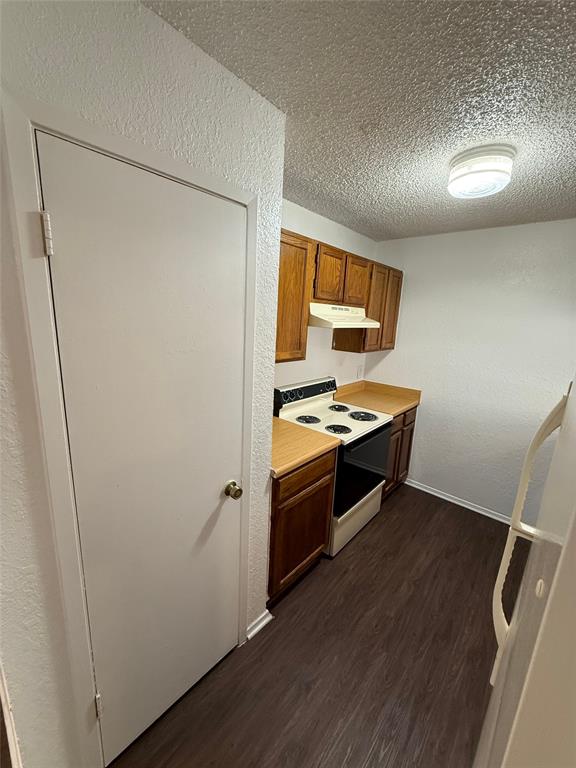 1715 Short Street, Unit D Cleburne, TX 76033 - Photo 9 of 12 Kitchen featuring wood-finish flooring and oak cabinetry