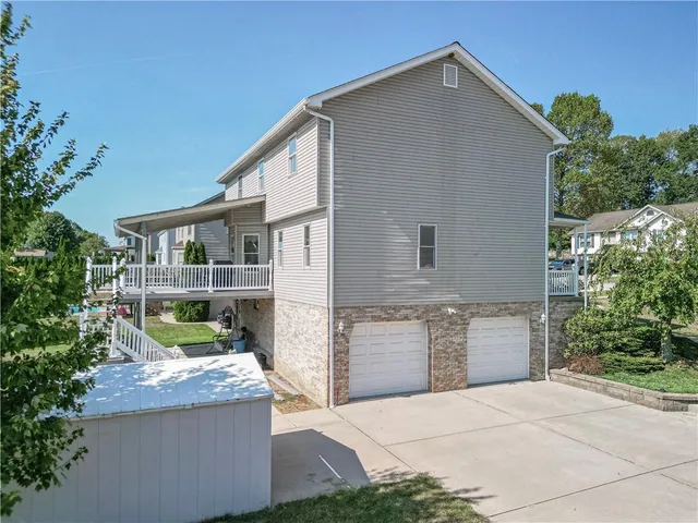 a view of backyard with large trees and a small yard