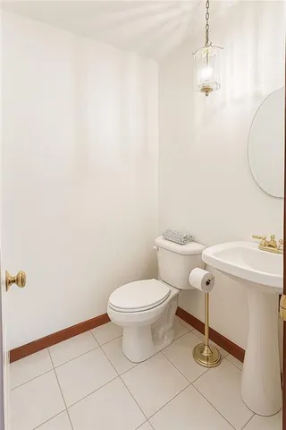 an empty room with fireplace and fan