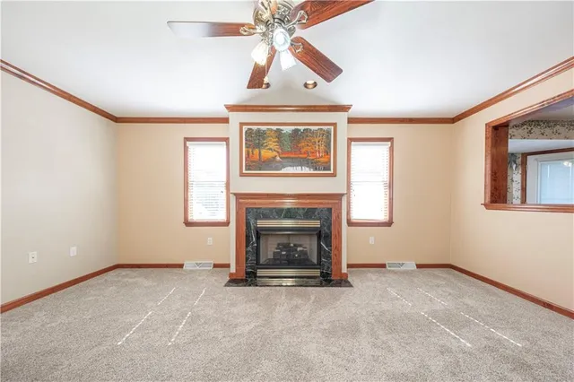 a view of a livingroom with a fireplace and window