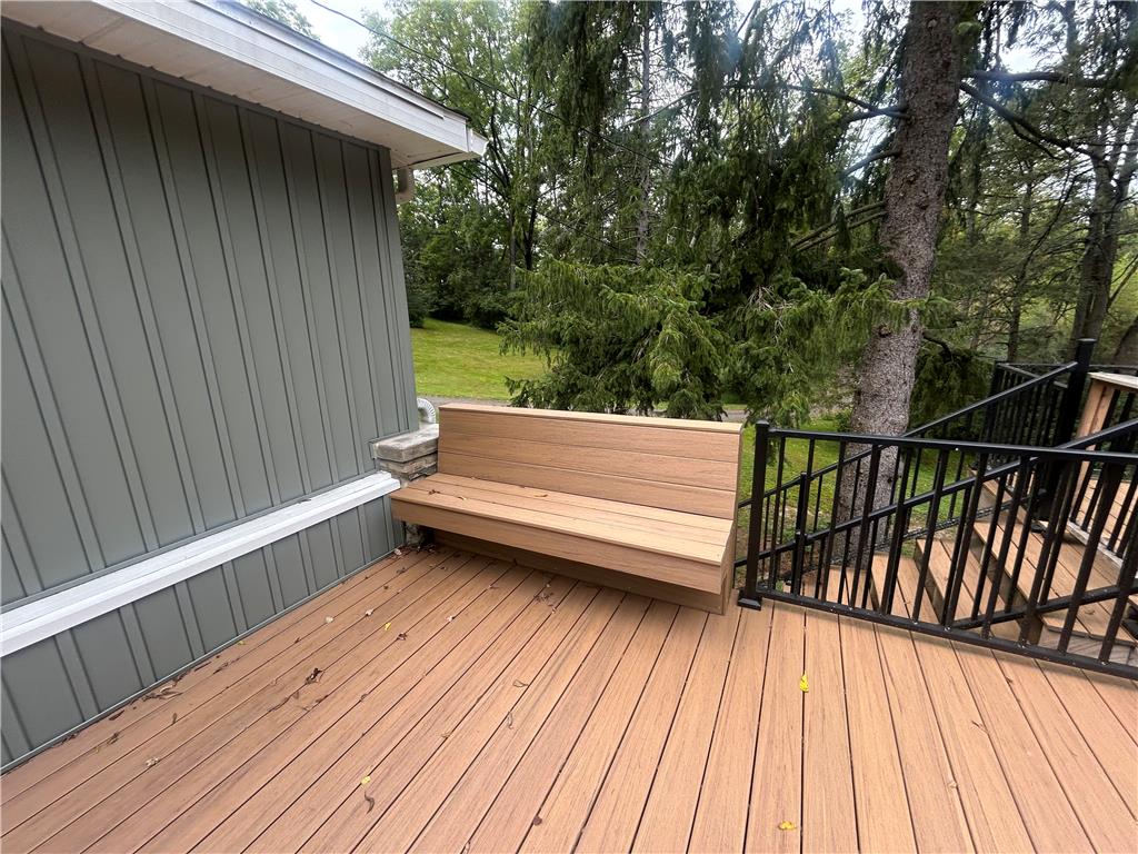 7 Allegheny Road Mount Bethel, PA 18343 - Photo 18 of 71 Mature trees frame the view from this spacious wooden deck featuring a built-in bench.