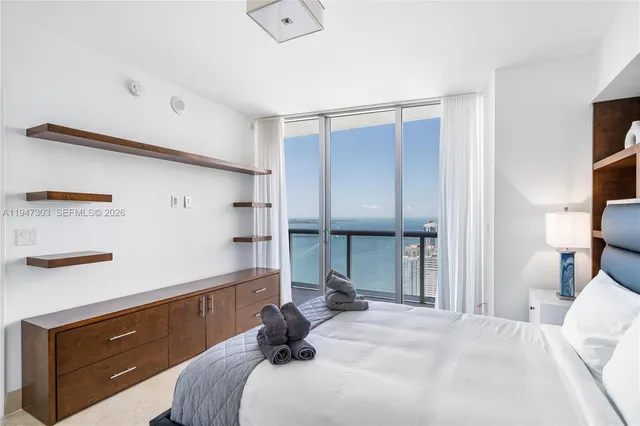 a bedroom with a bed and a tv on the dresser