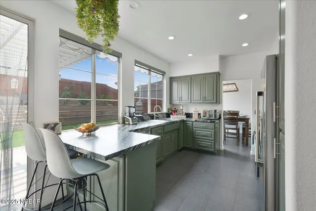 a kitchen with sink and refrigerator