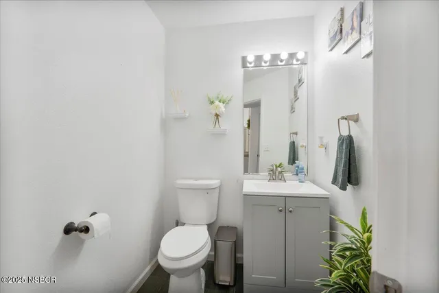 a bathroom with a sink toilet and mirror