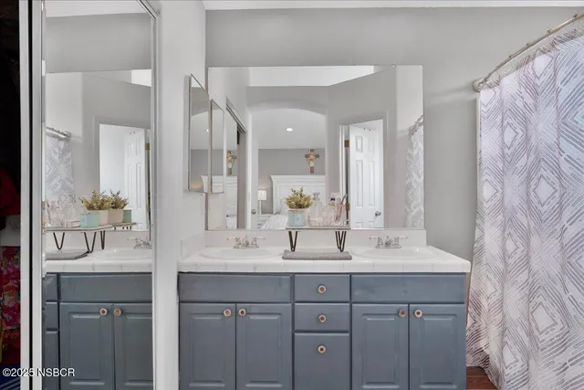 a bathroom with a double vanity sink and a mirror