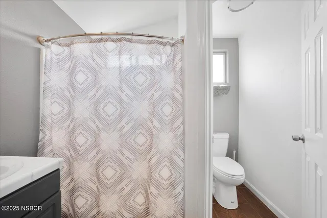 a white toilet sitting next to a bathroom sink