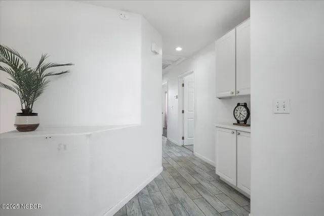 a view of hallway with wooden floor