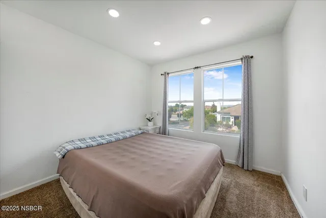 a bedroom with a bed and a mirror