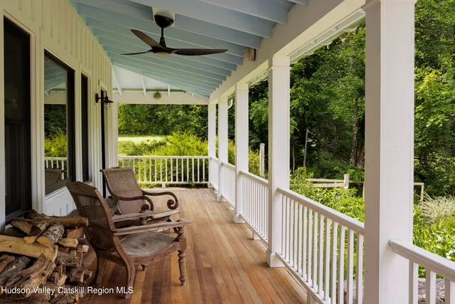 a view of a porch with furniture and garden