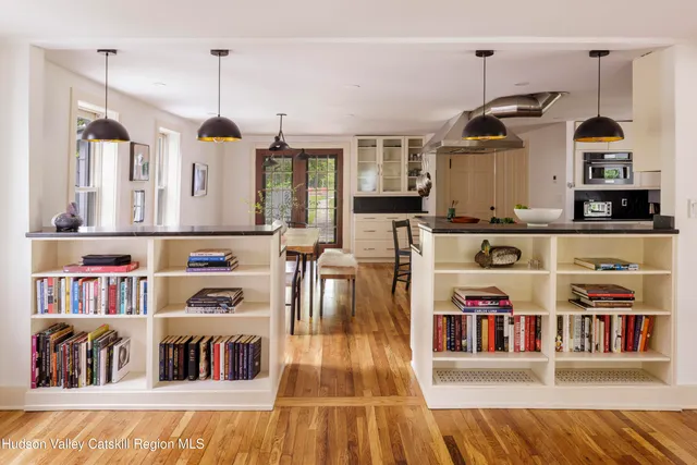 a living room with lots of furniture and a book shelf