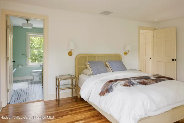 a bedroom with a bed and a view of bathroom
