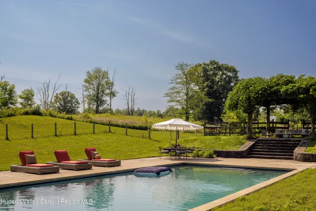 swimming pool view with a seating space