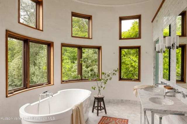 a bathroom with a tub a sink and a window