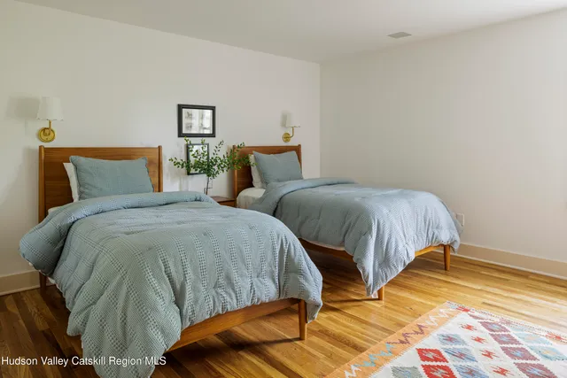 a bedroom with two beds and a lamp